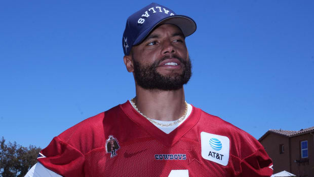 Cowboys quarterback Dak Prescott looks on.